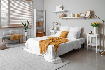 Wall Mural - Stylish interior of bedroom with yellow plaid and pillow on white comfortable bed