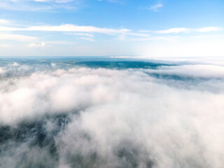 Poster - Beautiful nature white clouds Aerial view, blue sky horizon shooting from drone on sunny day high in the atmosphere front view