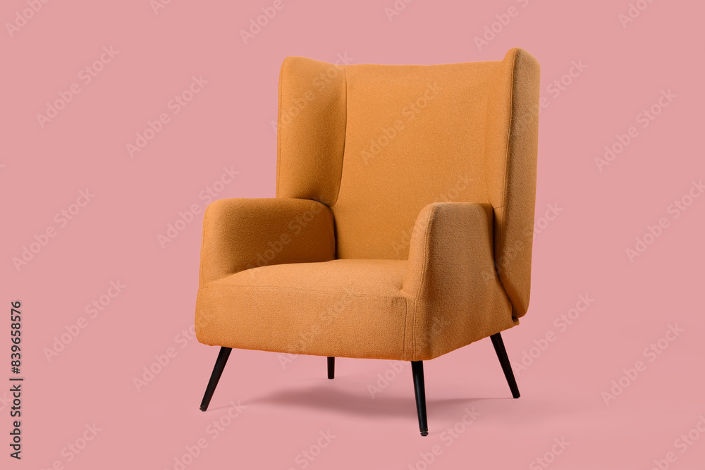 Cozy armchair on pink background