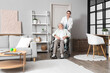 © Pixel-Shot - Senior woman in wheelchair with physical therapist at home