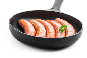 Wall Mural - Set of raw spicy sausages in frying pan isolated on white background