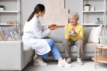 Poster - Senior woman and physical therapist with massage balls at home