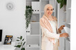 © Pixel-Shot - Beautiful Muslim businesswoman taking folder from shelf in office