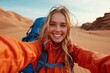 © Andrei - Cheerful woman capturing selfie in desert under sunny sky for memorable photograph