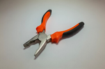 hand tool pliers with orange handle shot from different angles on a white background