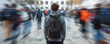 © GB - Male college student standing alone among a crowd of other students, concept of the feeling of isolation and loneliness due to mental illness