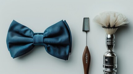Flat lay of men's accessories for a casual style, including a blue bow tie and barber brush with a razor on a white background. 