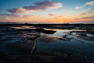 sunrise over the rocks on the coast