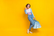 © deagreez - Full body photo of charming cheerful lady hold mall bags indicate finger empty space isolated on yellow color background