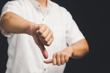 Wall Mural - Negative feedback. Close-up of hand showing a thumbs down for dislike service.