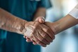 © Sandu - Close-up of person handshake nurse