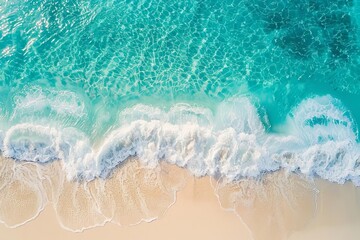 Wall Mural - Aerial view of turquoise ocean waves gently crashing onto a pristine sandy beach. Perfect for vacation or travel themes.