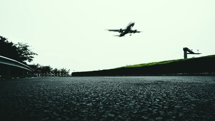 Canvas Print - Airplane flying over the asphalt road