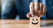 © Mark - Businessman chooses a smiley face from a wooden block. Excellent business rating experience. Satisfaction survey concept.
