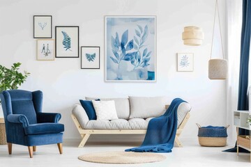 Wall Mural - White sofa and blue armchair in living room with posters on the wall