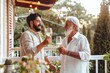 © Bundi - An elderly man and his senior father toast with wine after a family lunch on the patio.