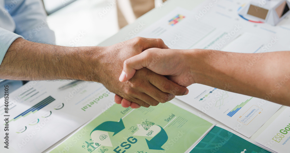 Closeup Asia businesspeople shaking hands over ESG strategic commitment ...