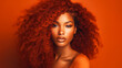 © ALA - Beautiful, sexy, happy smiling dark-skinned African American woman with perfect skin and red hair, on an orange background, banner.