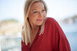 © Вероника Зеленина - Beautiful blond middle-aged woman dressed red shirt walking in the street. Outdoor portrait of a 55 - 60 s ears old woman. Close up of fashion urban outfit