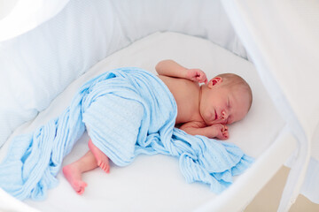 Wall Mural - Little baby on white bed