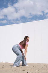 Canvas Print - plus size woman wearing casual clothes dancing on white wall background in the street