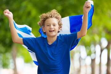 Wall Mural - Child running with Scotland flag