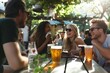 © mattegg - Friends laughing and drinking beer at a bar in the summertime
