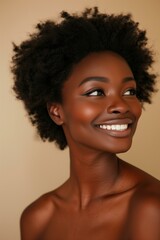 Wall Mural - African American woman smiling, glowing skin, with natural afro hairstyle, wearing minimal makeup, neutral beige background