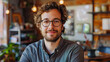 © Graphic Dude - Portrait of handsome man with curly hair looking at camera in cafe
