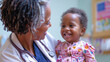 © Graphic Dude - African american pediatrician doctor with patient in hospital. Health care and medical concept.