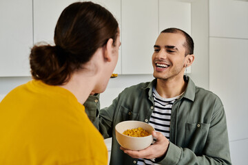 A young gay couple enjoys a casual breakfast together in their modern apartment.