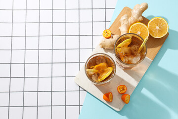 Wall Mural - Cold tea with ice, orange slices and mint leaves and ginger