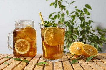 Wall Mural - Cold tea with fresh oranges and mint leaves