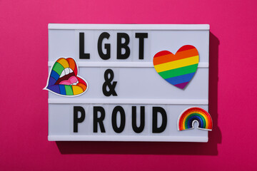 Wall Mural - LGBT parade concept, holiday symbols on pink background.