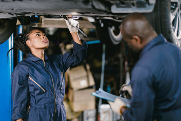 Wall Mural - Mechanic Team Man and Women Staff Working Repair Vehicle in Car Service. Professional Worker Fix Car in Workshop Together.