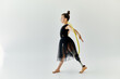 © Bliss - A young girl with a prosthetic leg practices gymnastics while spinning a yellow hoop.