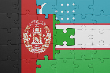 puzzle with the colourful national flag of uzbekistan and flag of afghanistan.