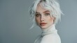© MD Media - Beautiful woman with white hair in a turtleneck, posing and looking at the camera isolated on a gray background. Fashion portrait of a young beautiful girl model wearing a short hairstyle