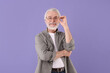 © New Africa - Portrait of stylish grandpa with glasses on purple background