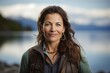 © CogniLens - Portrait of a glad woman in her 40s wearing a rugged jean vest over beautiful lagoon background