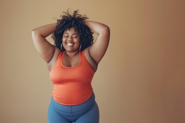 A portrait of a black woman with a gorgeous curly hairstyle wearing orange underwear is posing in a grab head pose with her two hands, which looks attractive and beautiful.