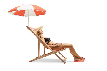 Wall Mural - Attractive young female in bikini sunbathing on a beach chair