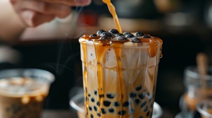 Poster - A hand stirring a glass of brown sugar bubble milk tea, the rich caramel hue swirling with the creamy base, promising a decadent treat for the taste buds