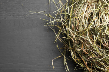 Poster - Dried hay on grey wooden table, top view. Space for text