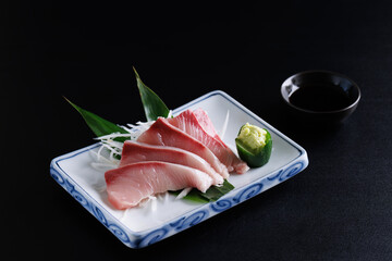 Wall Mural - Red Sea bass sashimi isolated in black background