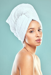 Poster - Portrait, woman and towel for hair in blue background, routine for healthy skincare and beauty. Face, female model and head cloth, natural glow for cosmetics or dermatology by wellness in studio