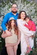 © anatoliy_gleb - Family allergic enjoying after treatment from seasonal allergy at spring. Happy mother, father and two daughters smiling in front of blossom tree at springtime. Spring allergy concept.