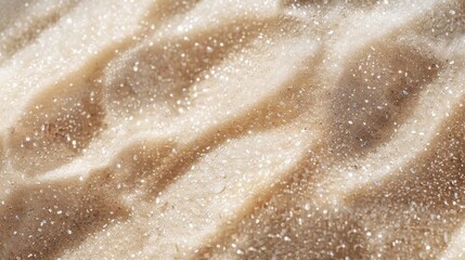 The surface of granular sugar resembles a sandy beach with dimples and tiny craters