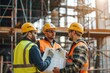 © spyrakot - Construction Workers Collaborating on Building Site Project - Safety Gear Coordination