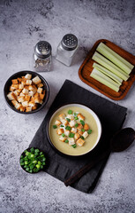 Wall Mural - Celery greens soup with scallions and croutons in a bowl